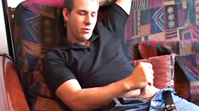 As the porn plays on the TV, Cory Woodall tugs on his cock. After pulling off his clothes, a helping hand begins to work his dick.