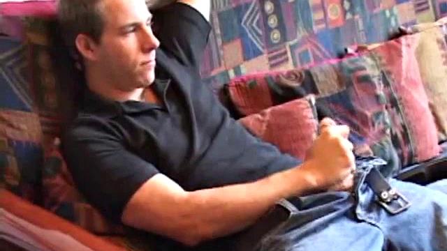 As the porn plays on the TV, Cory Woodall tugs on his cock. After pulling off his clothes, a helping hand begins to work his dick.