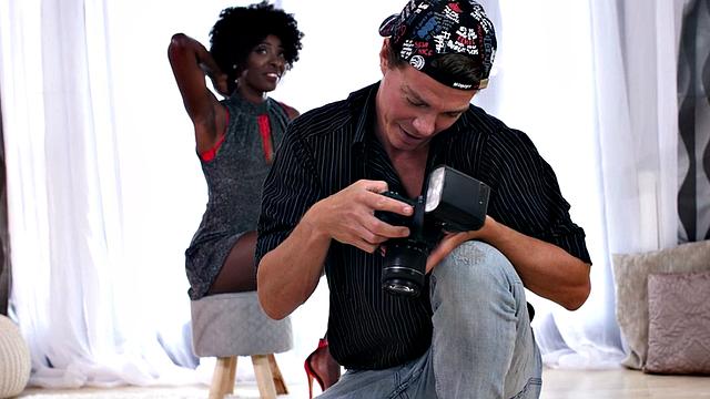 Watch as photographer devours hairy muff of black model in high heels and baseball cap