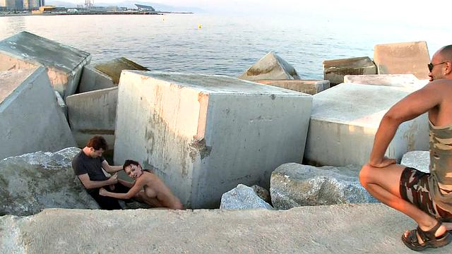 BDSM public slut deepthroats in front of outdoor voyeurs