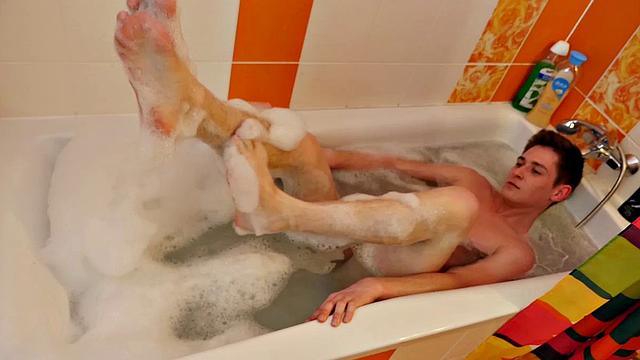 Adam fills his bathtub with warm sudsy water and dips his naked twink body down into the tub. Adam has an insatiable male foot fetish, especially for his own boy feet. He loves the warm water and the feel of the suds sliding down his soles.