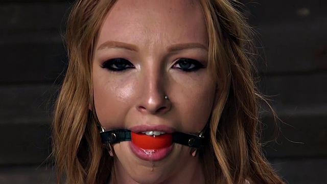 Kinky redhead gets her tight pussy and nipples dominated before getting a rough facefuck and spanking