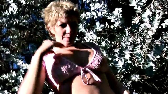 Short-haired blonde showing perfect tits in the open