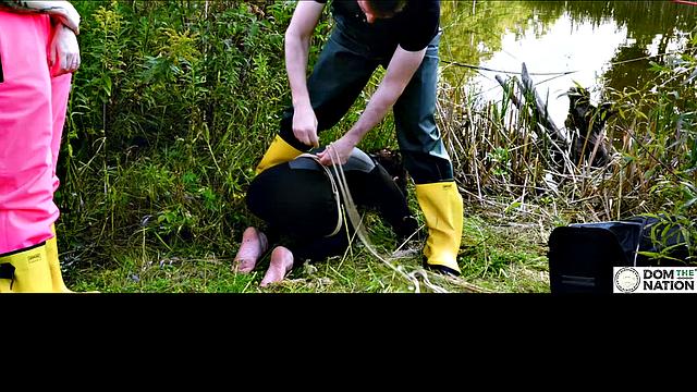 Lezdom babe in anal domination by a quiet serene river