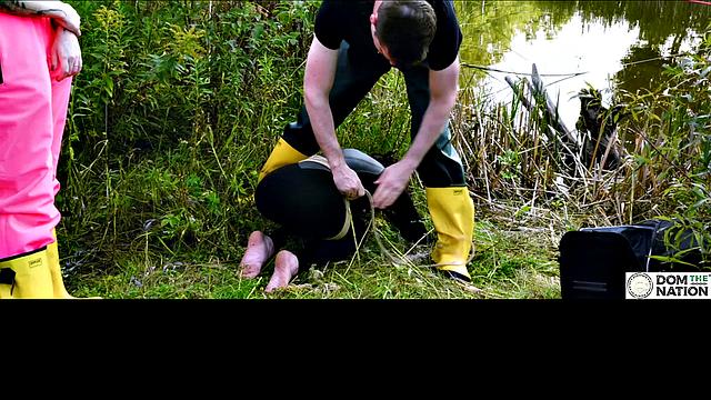 Lezdom babe in anal domination by a quiet serene river