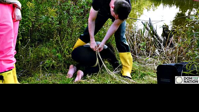 Lezdom babe in anal domination by a quiet serene river