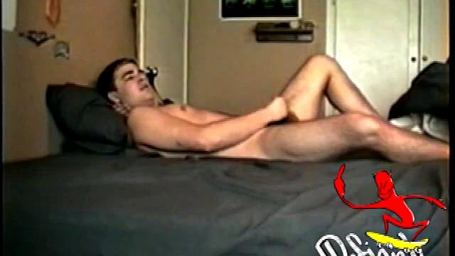 Horny Jon Hammer lies back on his bed to give us a nice stroke show. He cups his balls as he works his cock. This boy totally abuses that meat. Every now and then he gives a sly look to the camera, just to make sure we are paying attention.