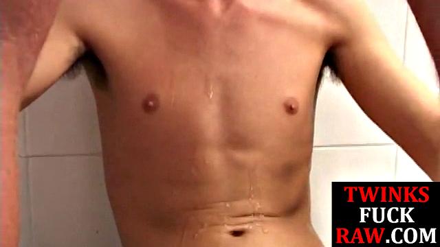 Cock tugged twink barebacked by top in shower