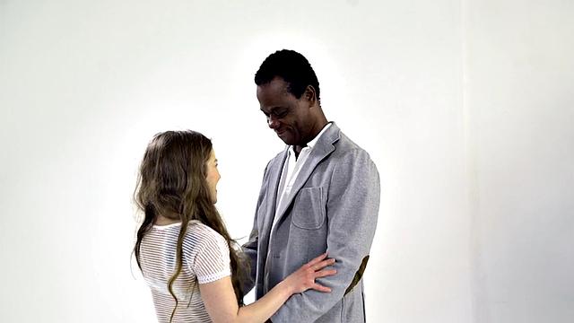 Petite babe rides senior in interracial duo before facial