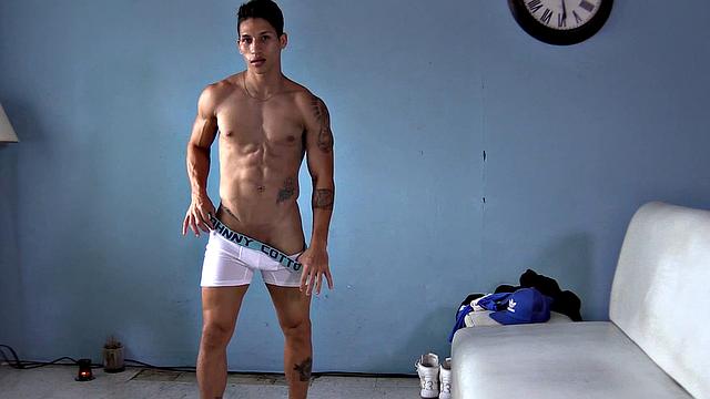 Ronaldo is a sexy and buffed Latin jock, and we have the pleasure of watching as he slowly strips naked and flexes his muscles. Standing, the inked young man gets busy working up a boner.