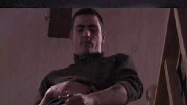 By the time the camera finds him, Dan is already going for his woody. He seems uncomfortable in the chair, so he stands up and moves to the staircase, where we can see his cock getting harder and harder.