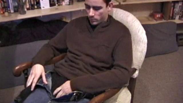 By the time the camera finds him, Dan is already going for his woody. He seems uncomfortable in the chair, so he stands up and moves to the staircase, where we can see his cock getting harder and harder.