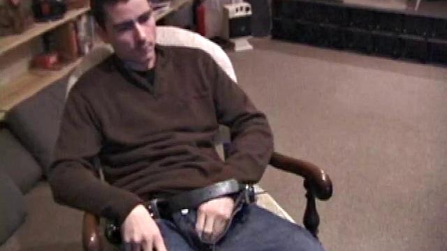 By the time the camera finds him, Dan is already going for his woody. He seems uncomfortable in the chair, so he stands up and moves to the staircase, where we can see his cock getting harder and harder.