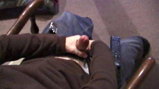 By the time the camera finds him, Dan is already going for his woody. He seems uncomfortable in the chair, so he stands up and moves to the staircase, where we can see his cock getting harder and harder.