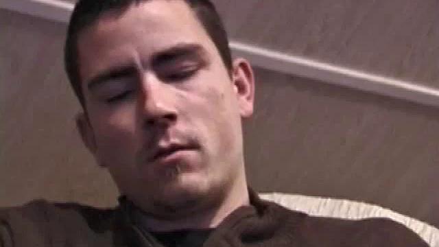 By the time the camera finds him, Dan is already going for his woody. He seems uncomfortable in the chair, so he stands up and moves to the staircase, where we can see his cock getting harder and harder.