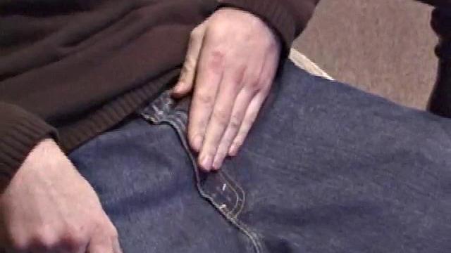 By the time the camera finds him, Dan is already going for his woody. He seems uncomfortable in the chair, so he stands up and moves to the staircase, where we can see his cock getting harder and harder.