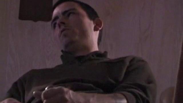 By the time the camera finds him, Dan is already going for his woody. He seems uncomfortable in the chair, so he stands up and moves to the staircase, where we can see his cock getting harder and harder.