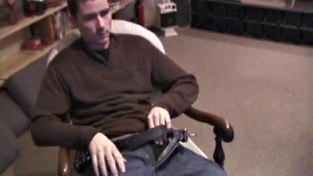 By the time the camera finds him, Dan is already going for his woody. He seems uncomfortable in the chair, so he stands up and moves to the staircase, where we can see his cock getting harder and harder.