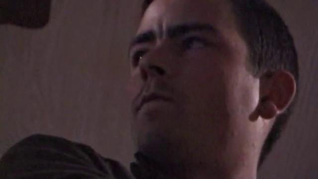 By the time the camera finds him, Dan is already going for his woody. He seems uncomfortable in the chair, so he stands up and moves to the staircase, where we can see his cock getting harder and harder.