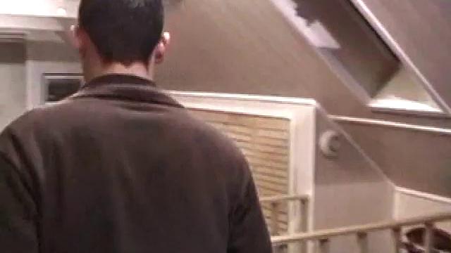 By the time the camera finds him, Dan is already going for his woody. He seems uncomfortable in the chair, so he stands up and moves to the staircase, where we can see his cock getting harder and harder.