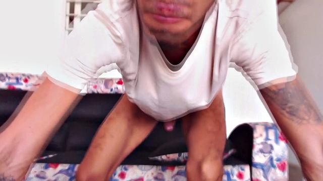 Juan sits on the floor, plays with himself, and reveals his stiff uncut cock. Moving to the sofa, he beats off naked.