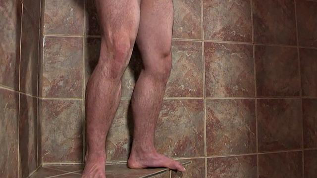 Masked solo jock wanks dick in shower till cumshot