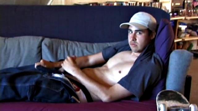 This 21 year old skater boy leans back on a sofa and rubs his bulge through some pretty heavy jeans and then, after unzipping, through the fly of his boxers. Getting stiffer, Mark shows off his nice boner while staring into the camera.
