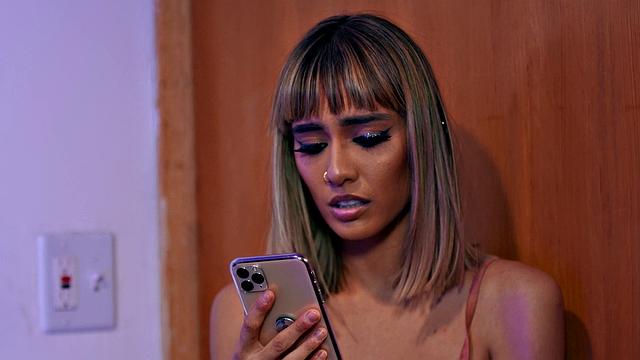 Curly-haired babe in red lingerie enjoys threesome action in bedroom