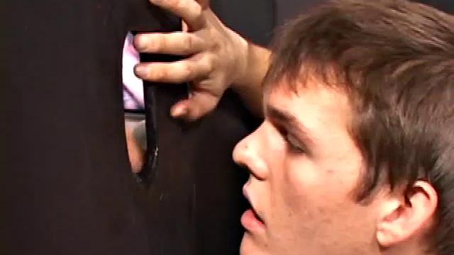 Sucking on a huge dick through a glory hole, 20 year old Nick shows his oral skills. The guy receiving the blow job loves it and in no time the stud strokes his cum load onto Nick's face.