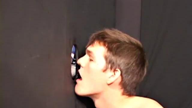 Sucking on a huge dick through a glory hole, 20 year old Nick shows his oral skills. The guy receiving the blow job loves it and in no time the stud strokes his cum load onto Nick's face.