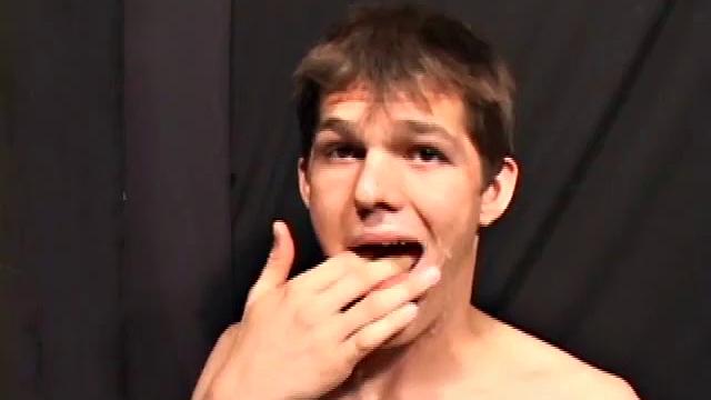 Sucking on a huge dick through a glory hole, 20 year old Nick shows his oral skills. The guy receiving the blow job loves it and in no time the stud strokes his cum load onto Nick's face.