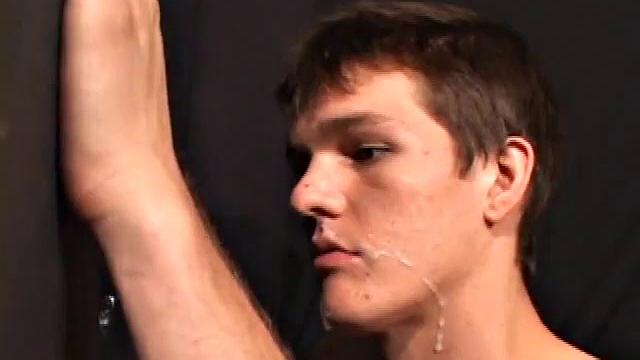 Sucking on a huge dick through a glory hole, 20 year old Nick shows his oral skills. The guy receiving the blow job loves it and in no time the stud strokes his cum load onto Nick's face.