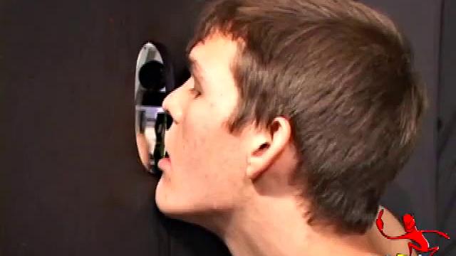Sucking on a huge dick through a glory hole, 20 year old Nick shows his oral skills. The guy receiving the blow job loves it and in no time the stud strokes his cum load onto Nick's face.