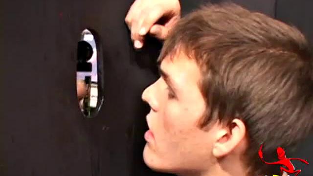 Sucking on a huge dick through a glory hole, 20 year old Nick shows his oral skills. The guy receiving the blow job loves it and in no time the stud strokes his cum load onto Nick's face.
