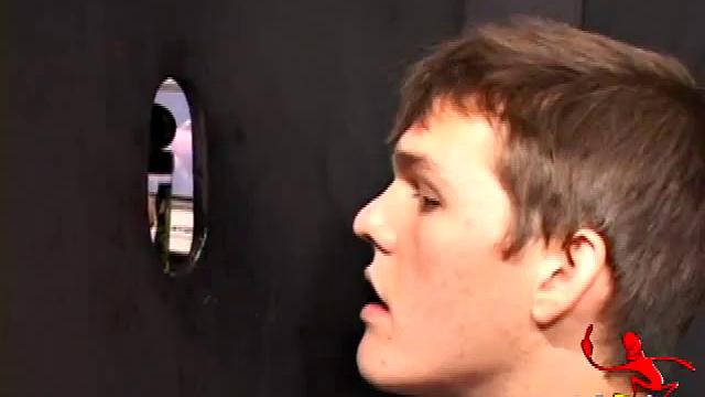 Sucking on a huge dick through a glory hole, 20 year old Nick shows his oral skills. The guy receiving the blow job loves it and in no time the stud strokes his cum load onto Nick's face.