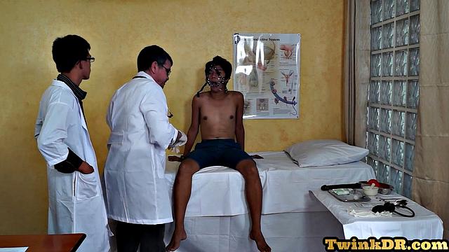 Asian doctors examining twink's butt