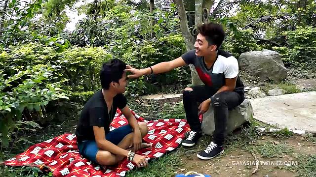 Two cute Asian twinks Idol and Nathan find the outdoor air invigorating and it's making them horny. Nobody is around so they start making out on a blanket. Soon they are naked and enjoy some ass rimming.