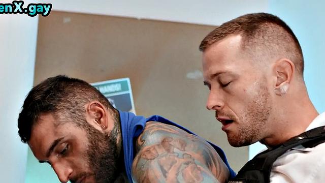 Manly jock with muscled inked body fucks policeman in the toilet