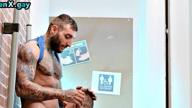 Manly jock with muscled inked body fucks policeman in the toilet