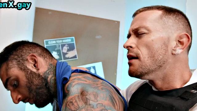 Manly jock with muscled inked body fucks policeman in the toilet