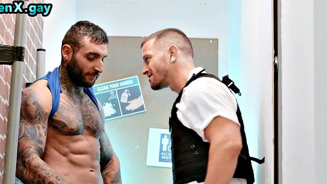 Manly jock with muscled inked body fucks policeman in the toilet