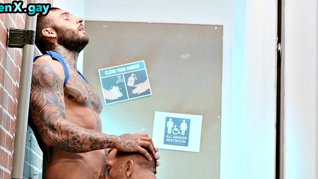 Manly jock with muscled inked body fucks policeman in the toilet