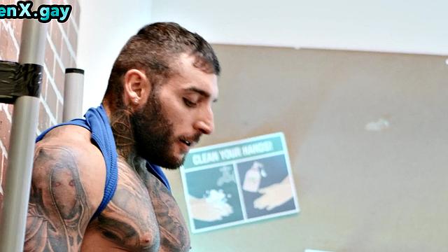 Manly jock with muscled inked body fucks policeman in the toilet