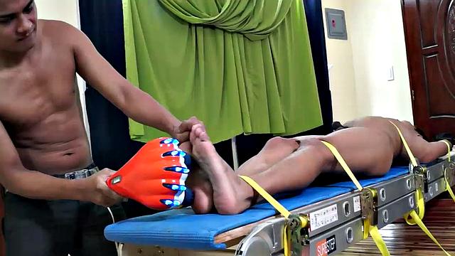 We just can't get enough of gorgeous Gil! We brought him back for some tickle fun, and this time we strapped him on our tickle rack.