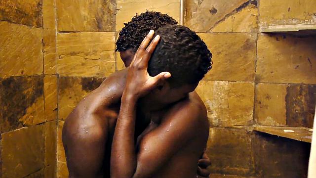 Sucking black twink from behind in erotic action