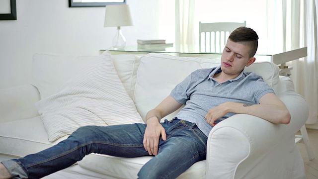 Tattooed twink tugging thick cock while showing body