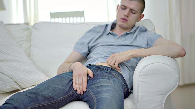 Tattooed twink tugging thick cock while showing body