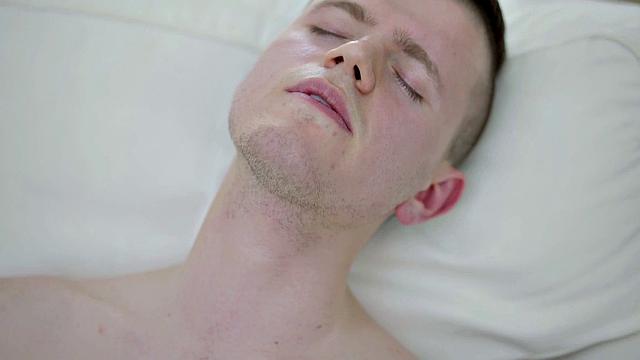 Tattooed twink tugging thick cock while showing body