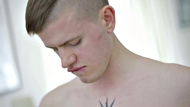 Tattooed twink tugging thick cock while showing body