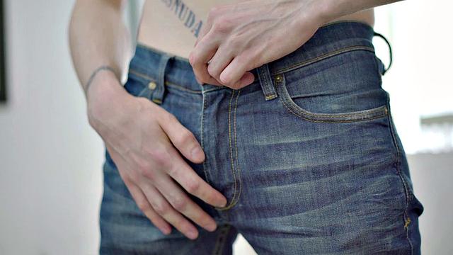 Tattooed twink tugging thick cock while showing body